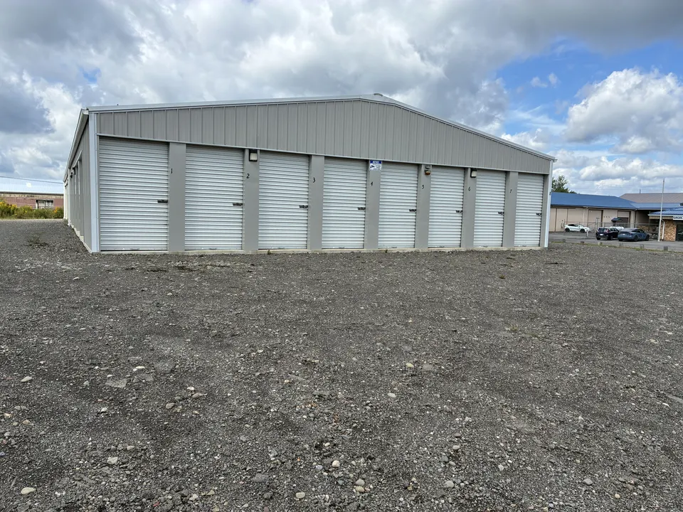 Row of numbered storage units under a dramatic sky